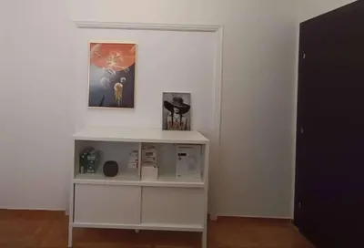 a white shelf in a room with a picture on the wall at Sunny two-bedroom apartment next to Panathenaic Stadium in Athens