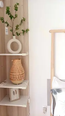 a shelf with a vase and a plant on it at Sunny two-bedroom apartment next to Panathenaic Stadium in Athens