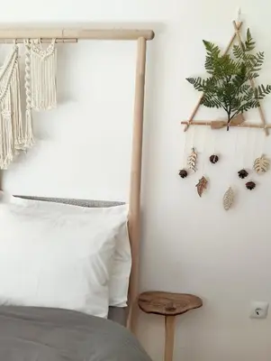 a bedroom with a bed and a plant on a wall at Sunny two-bedroom apartment next to Panathenaic Stadium in Athens