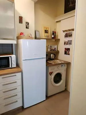 a kitchen with a white refrigerator and a washing machine at Still got the blues in Athens