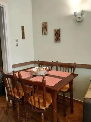 a dining room table with four chairs and a table at Still got the blues in Athens