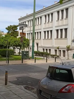 a car parked on a street in front of a building at Still got the blues in Athens