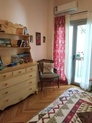 a bedroom with a dresser and a chair and a window at Still got the blues in Athens
