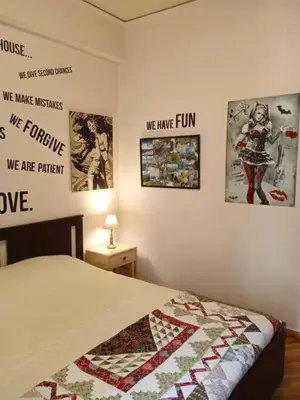 a bedroom with a bed with posters on the wall at Still got the blues in Athens