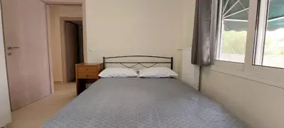 a small bedroom with a bed and a window at Cozy apartment in Nea Smyrni in Athens