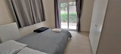 a small bedroom with a bed and a window at Cozy apartment in Nea Smyrni in Athens