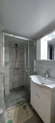 a bathroom with a shower and a sink and a mirror at Cozy apartment in Nea Smyrni in Athens