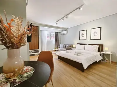 a bedroom with a bed and a living room at 5min Metro, Sotiria, Iatriko, Semi-Basement in Athens
