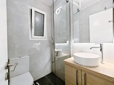 a bathroom with a sink and a toilet and a mirror at 5min Metro, Sotiria, Iatriko, Semi-Basement in Athens