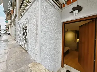 a hallway of a building with a wooden door at 5min Metro, Sotiria, Iatriko, Semi-Basement in Athens