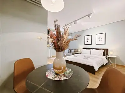 a bedroom with a bed and a table with a vase on it at 5min Metro, Sotiria, Iatriko, Semi-Basement in Athens