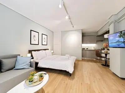 a living room with a bed and a couch at 5min Metro, Sotiria, Iatriko, Semi-Basement in Athens