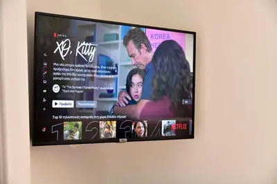 a flat screen tv hanging on a wall at Dunant Studio in Athens