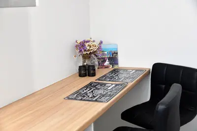 a wooden desk with a vase of flowers and a chair at Dunant Studio in Athens
