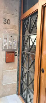 a door to a wine cellar with a sign on it at Dunant Studio in Athens