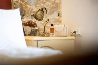 a lamp sitting on top of a table with a bag at Queen's stone legend, royal living by Acropolis in Athens