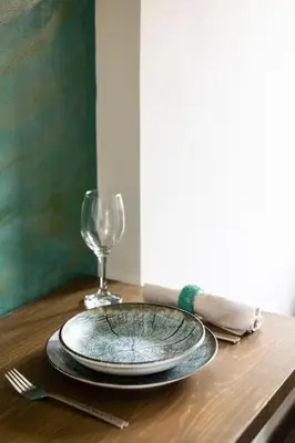 a plate and a wine glass on a table at Queen's stone legend, royal living by Acropolis in Athens