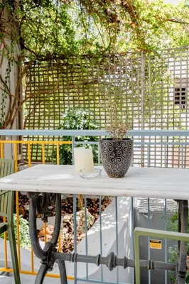 a table with a vase sitting on top of it at Canto-Home Alongside The Acropolis in Athens