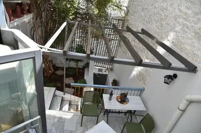 an overhead view of a balcony with a table and chairs at Canto-Home Alongside The Acropolis in Athens