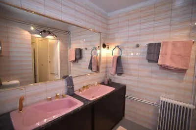 a bathroom with two sinks and a large mirror at Canto-Home Alongside The Acropolis in Athens