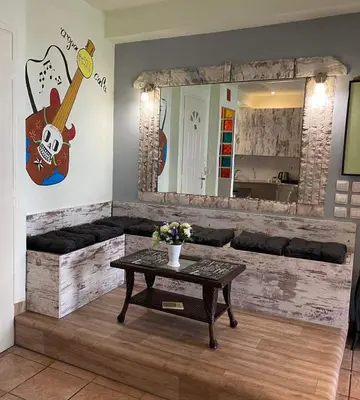 a living room with a table and a mirror at Athens Victoria's studio in Athens
