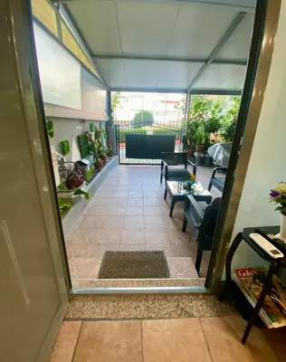 a view from the inside of a greenhouse with a living room at Athens Victoria's studio in Athens