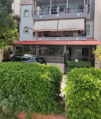 a car parked in front of a building with bushes at Athens Victoria's studio in Athens