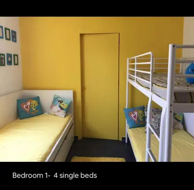 two bunk beds in a room with yellow walls at Summer House / Πόρτο Ράφτη in Porto Rafti