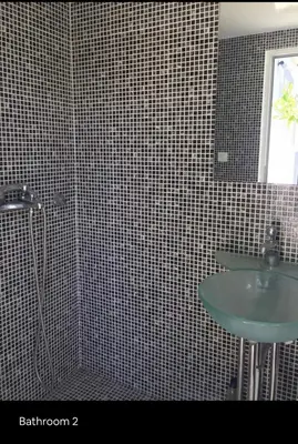 a bathroom with a shower and a sink and a mirror at Summer House / Πόρτο Ράφτη in Porto Rafti