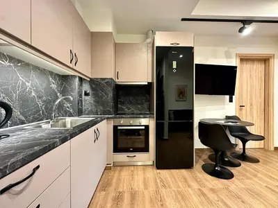 a kitchen with a sink and a table in it at T&T Luxury Apartments - Rooftop Jacuzzi in Athens