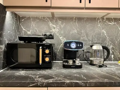 a kitchen counter with a coffee maker and a toaster at T&T Luxury Apartments - Rooftop Jacuzzi in Athens