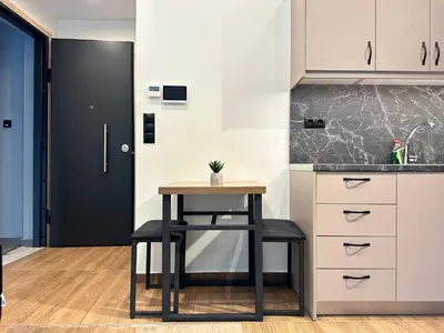 a kitchen with a table and a black door at T&T Luxury Apartments - Rooftop Jacuzzi in Athens