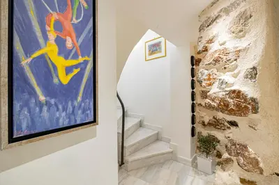a staircase in a house with a painting on the wall at ART-W Executive Apartments in Athens