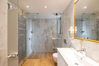 a bathroom with a shower and a sink and a toilet at ART-W Executive Apartments in Athens