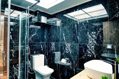 a bathroom with a toilet and a glass shower at Ancient Agora Hideaway in Athens