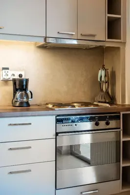 a kitchen with a stove and white cabinets at Cozy - Bright & New apart. - Downtown in Athens
