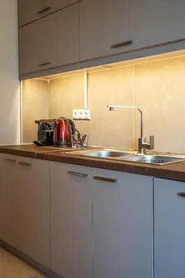 a kitchen with white cabinets and a sink at Cozy - Bright & New apart. - Downtown in Athens