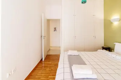 a room with a bed with towels on it at Cozy - Bright & New apart. - Downtown in Athens