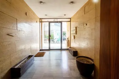 a hallway of a building with a large glass door at Cozy - Bright & New apart. - Downtown in Athens