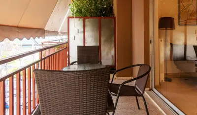 a balcony with two chairs and a table and a plant at Cozy - Bright & New apart. - Downtown in Athens