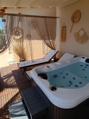 a jacuzzi tub in a room with a patio at Grand Villa Nefeli - Pool & Jacuzzi in Lagonissi