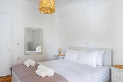 a bedroom with a white bed with towels on it at IVY Charm Acropolis View 2BR Apartment Neos Kosmos in Athens