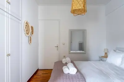 a bedroom with a bed with white towels on it at IVY Charm Acropolis View 2BR Apartment Neos Kosmos in Athens