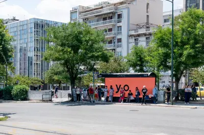 a group of people standing in front of a large billboard at IVY Charm Acropolis View 2BR Apartment Neos Kosmos in Athens