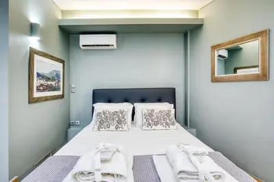 a bedroom with a bed with towels on it at Acropolis Urban View in Athens