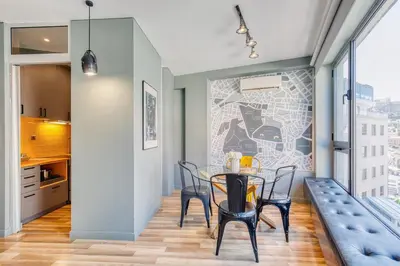 a kitchen and dining room with a table and chairs at Acropolis Urban View in Athens