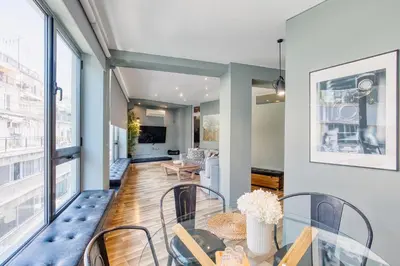 a dining room with a glass table and chairs at Acropolis Urban View in Athens