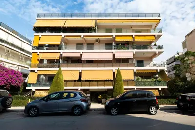 two cars parked in front of a building at The Glyfada Hideaway in Athens