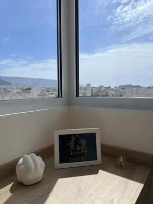 a picture frame sitting on a floor in a room with a window at Dafnis View in Athens