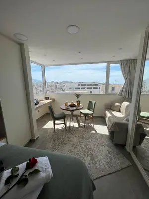 a bedroom with a bed and a table and a couch at Dafnis View in Athens